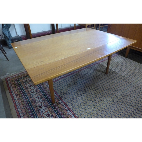 9 - A Danish teak metamorphic dining/coffee table