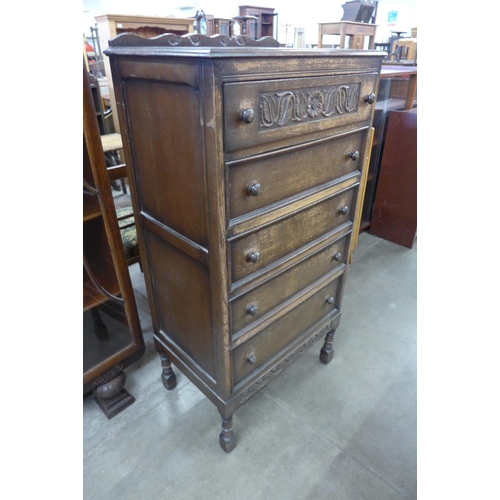 96 - A 17th Century style carved oak chest of drawers