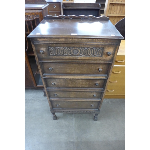 96 - A 17th Century style carved oak chest of drawers