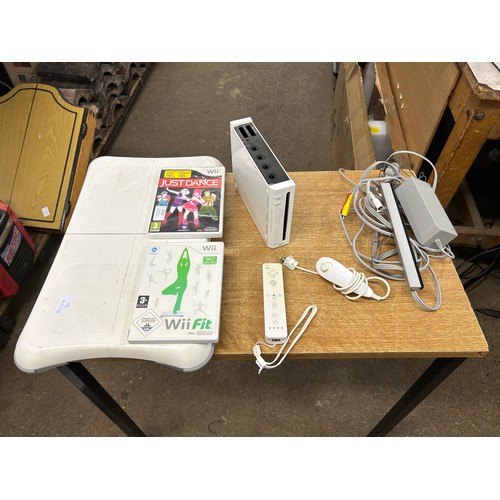 2122 - A Nintendo Wii with controller, joystick, Wii board, Just Dance and Wii Fit