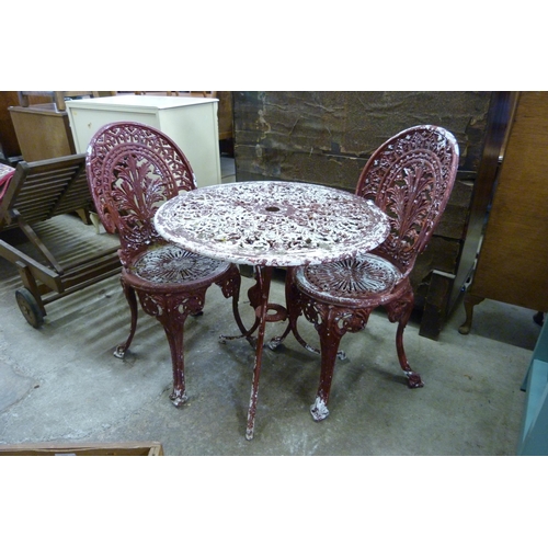 259 - A cast alloy garden table and two chairs