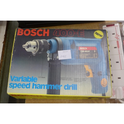 2045 - A Bosch 400E drill with 3 extension cables, an empty tool case and two battery chargers