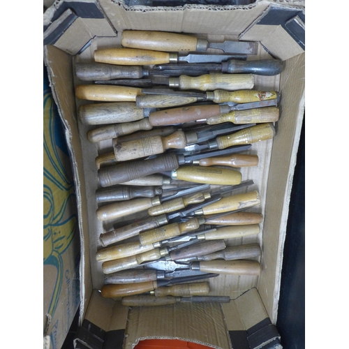 2058 - A box of chisels and approximately 38 wooden handles