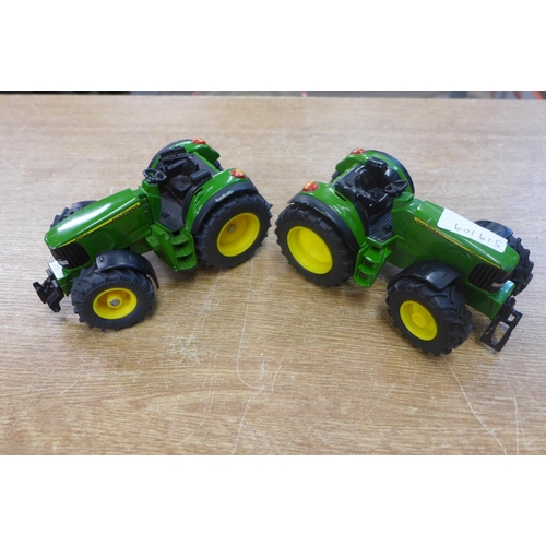 2118 - Two die-cast model John Deere tractors