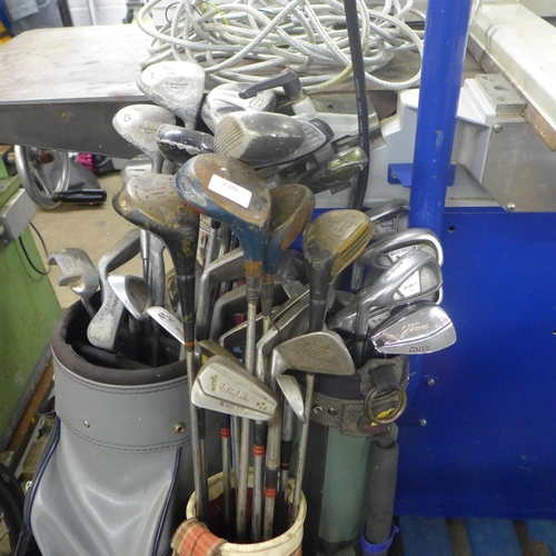 2206 - Three golf bags with approximately 25 golf clubs