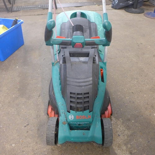 2326 - A Bosch lawn mower, two spare collectors and a box of jet wash parts