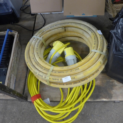 2436 - A 110v extension cable and a coil of compressor hose - 19 x 25 x 15mtrs - 20 bar/300PSi