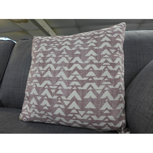 1474 - A grey upholstered three seater sofa with patterned scatter cushions and a footstool