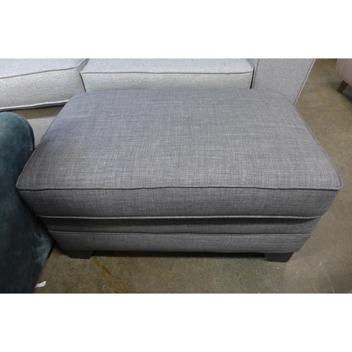 1474 - A grey upholstered three seater sofa with patterned scatter cushions and a footstool