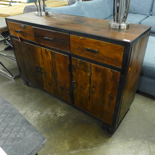 1496 - An industrial style hardwood and metal three door, three drawer sideboard on wheels  *This lot is su... 