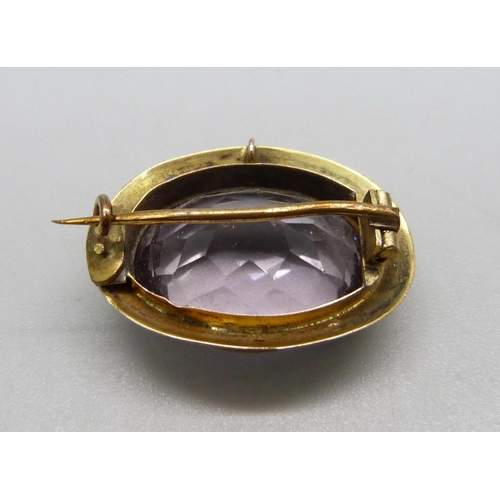 1023 - An antique 9ct gold mounted amethyst brooch, marked 9ct gold on the hinge, boxed