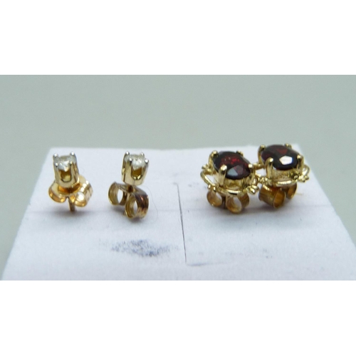 1051 - A pair of 9ct gold and diamond ear studs and a pair of 9ct gold and garnet earrings