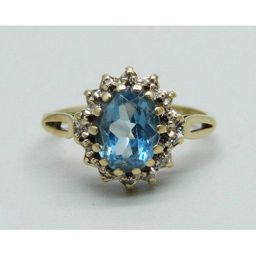 1054 - A 9ct gold, topaz and diamond cluster ring, 2.2g, M