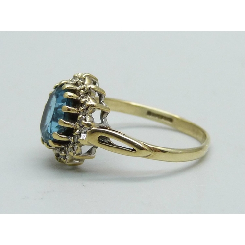 1054 - A 9ct gold, topaz and diamond cluster ring, 2.2g, M