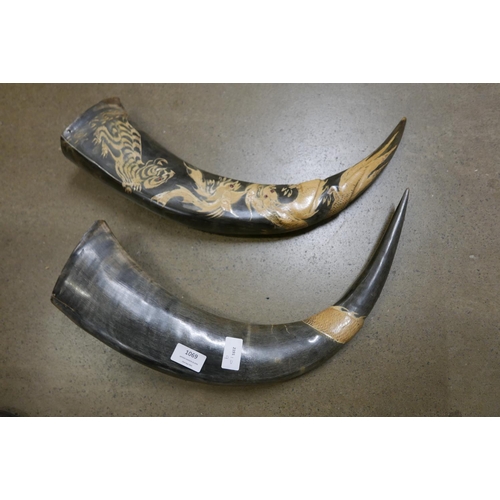 1069 - Two large carved horns with oriental detail