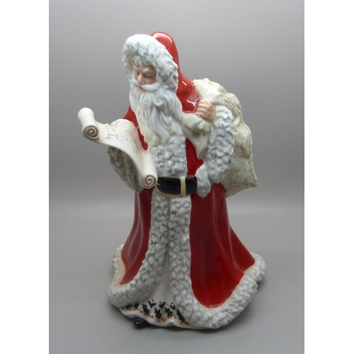 606 - A Royal Doulton Father Christmas figure, HN3399, (three small chips on the hood of the cloak)