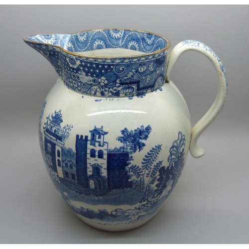 611 - A Georgian blue and white pearlware jug depicting a boy with oxen