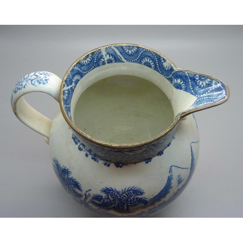 611 - A Georgian blue and white pearlware jug depicting a boy with oxen