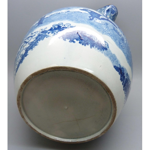 611 - A Georgian blue and white pearlware jug depicting a boy with oxen