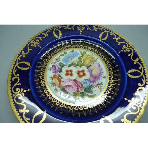 614 - A circa 1830 royal blue cabinet plate with hand painted floral decoration, (some scratches and wear ... 