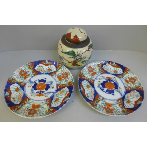 700 - Two Imari plates and a ginger jar