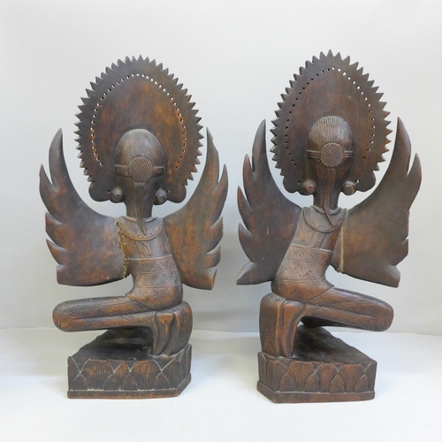 726 - A pair of carved wooden Balinese figures