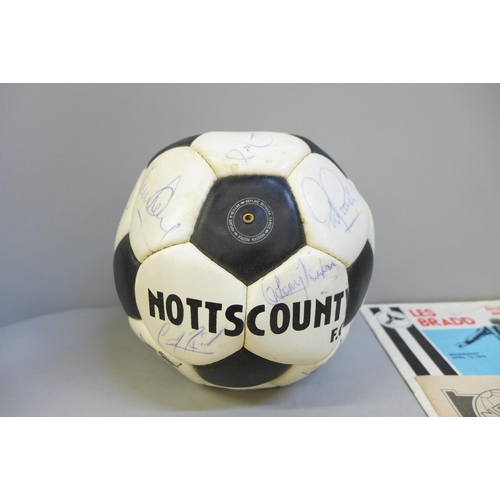 760 - Football memorabilia; a Notts County signed football from Les Bradd Testimonial and accompanying pro... 