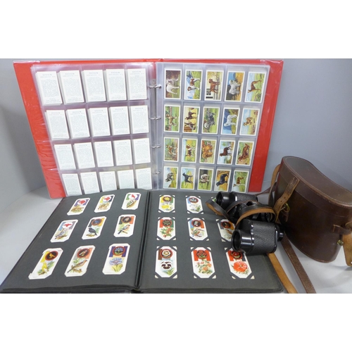 785 - Two cigarette card albums containing cards relating to footballers, birds, Grand National horses, av... 