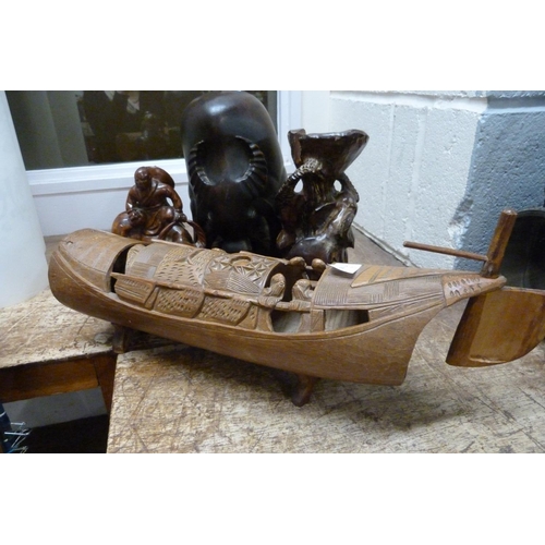 812 - A carved bamboo boat and three carved Asian figures