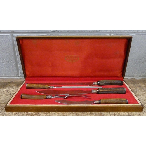 817 - A Stag Horn four-piece carving set by Lewis and  Co., cased