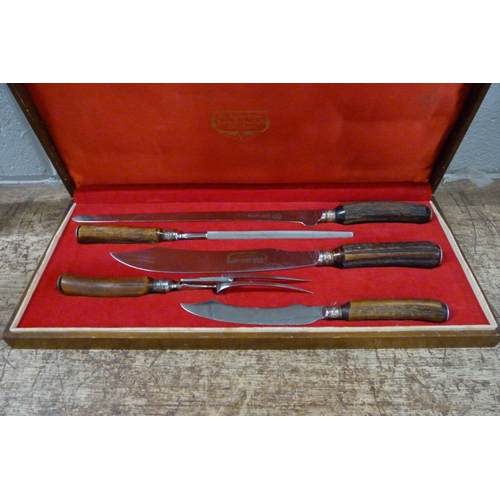 817 - A Stag Horn four-piece carving set by Lewis and  Co., cased