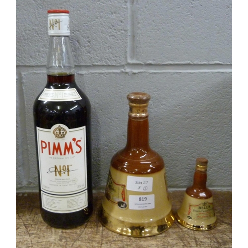 819 - Two Bell's Scotch Whisky decanters and a bottle of Pimms