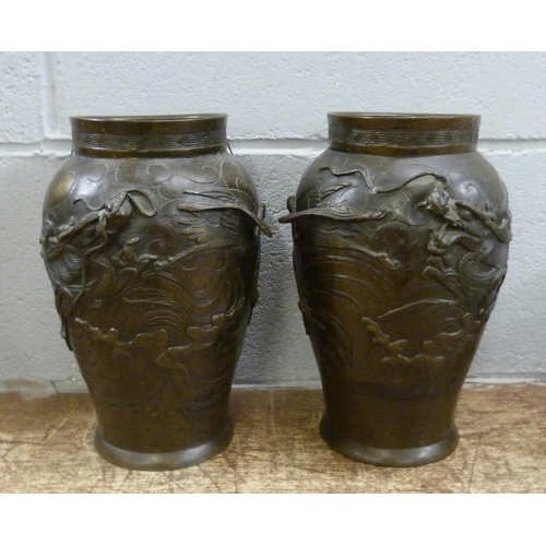 820 - A pair of Japanese Meiji bronze vases, decorated with dragons and birds, both a/f