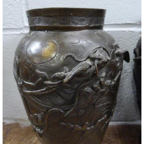 820 - A pair of Japanese Meiji bronze vases, decorated with dragons and birds, both a/f