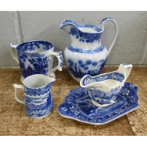 821 - Blue and white china; Death of Punch dish, a loving mug and three jugs