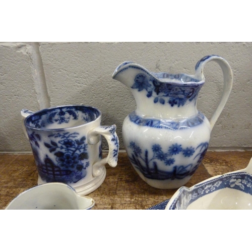 821 - Blue and white china; Death of Punch dish, a loving mug and three jugs