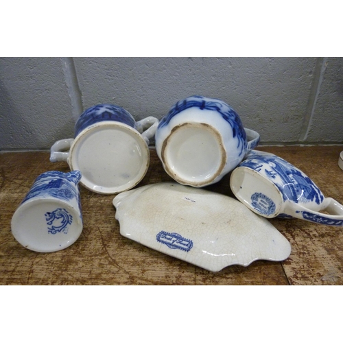 821 - Blue and white china; Death of Punch dish, a loving mug and three jugs