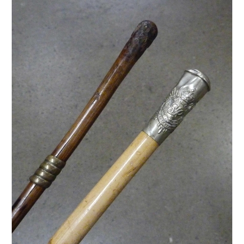 831 - Two swagger sticks; one George VI Army Service