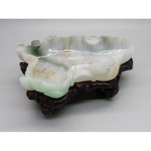 834 - A jade dish on a wooden stand, length 12.5cm