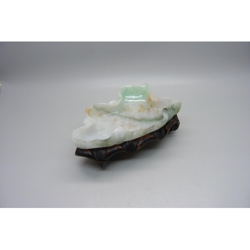 834 - A jade dish on a wooden stand, length 12.5cm