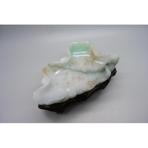 834 - A jade dish on a wooden stand, length 12.5cm