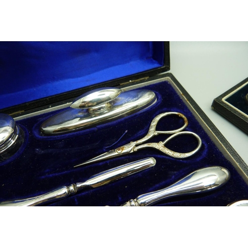 848 - A silver handled shoehorn and hook set and silver mounted manicures, (matched tweezers and scissors)