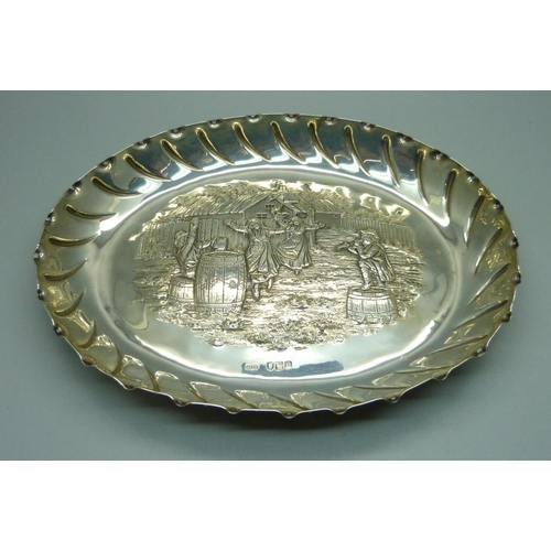 852 - An oval silver tray with embossed scene of an outside tavern, ladies dancing to a piper with seated ... 