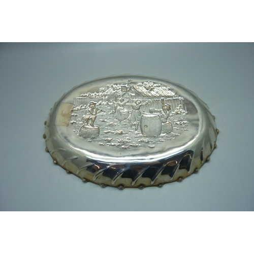 852 - An oval silver tray with embossed scene of an outside tavern, ladies dancing to a piper with seated ... 