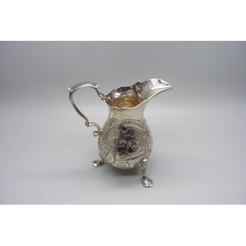 853 - A George II silver cream jug, London 1744, with pigeon and other bird detail, 101g