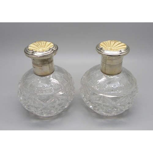 855 - A pair of silver and enamel cut glass scent bottles, Birmingham 1934, enamel a/f on one