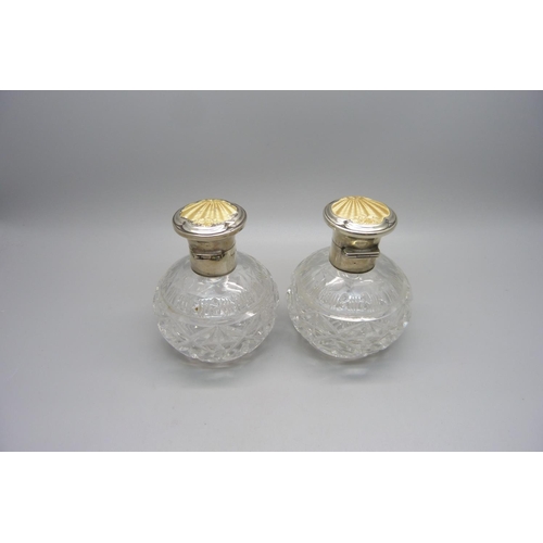 855 - A pair of silver and enamel cut glass scent bottles, Birmingham 1934, enamel a/f on one