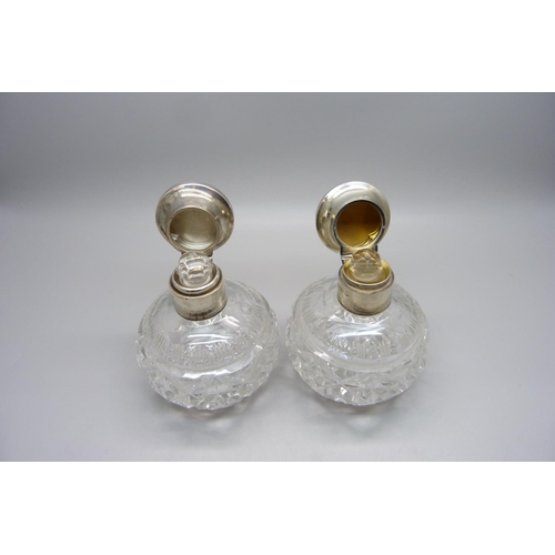 855 - A pair of silver and enamel cut glass scent bottles, Birmingham 1934, enamel a/f on one