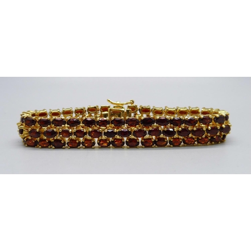 866 - A silver gilt, three row garnet bracelet