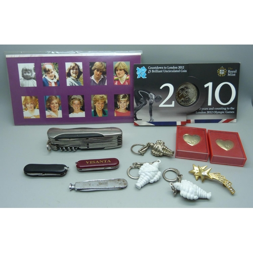 876 - A collection of penknives a Higear utility knife, three keyrings, Princess Diana stamps, a £5 2012 c... 